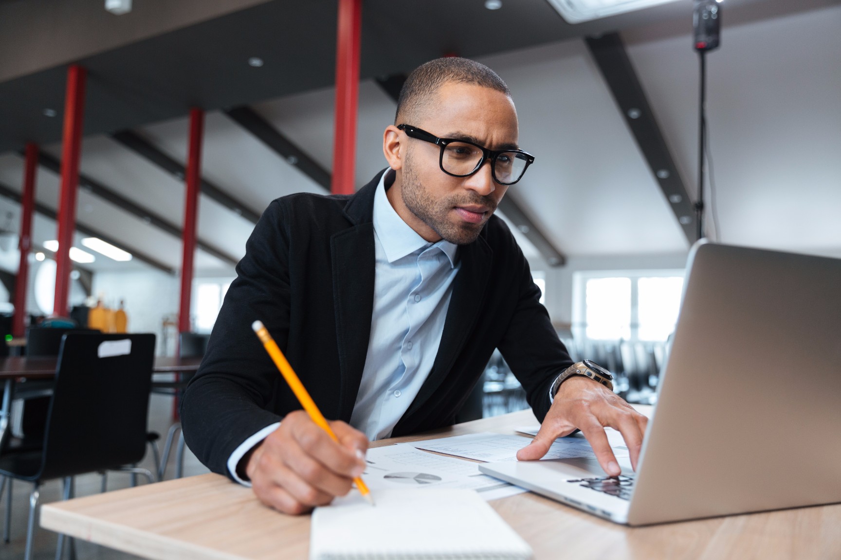 young-employee-looking-at-computer-monitor-PZ4JEMS
