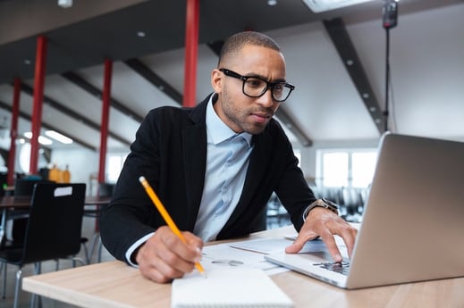 young-employee-looking-at-computer-monitor-PZ4JEMS-min